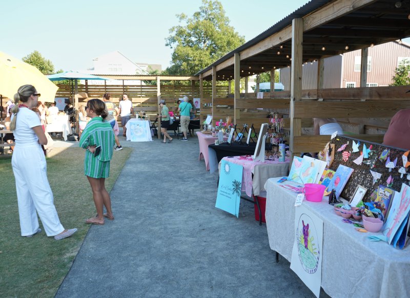 People shop around and chat during the showcase.