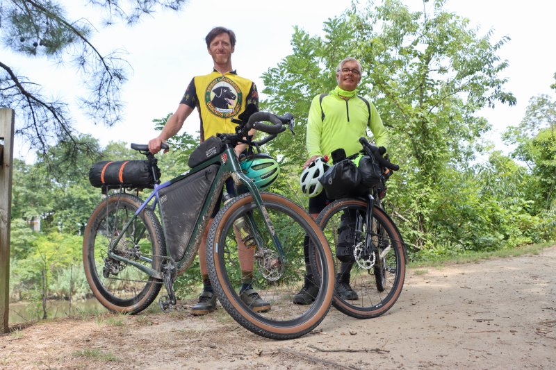 Jeremy May, left, and Thomas Knott stand across from the Canalside Inn in Rehoboth Beach. The pair ended a coast-to-coast bike ride in Lewes Aug. 4. They did not know each other when each man set out from the West Coast, but they met at a McDonald’s in Nebraska and decided to continue parts of the trip together. BILL SHULL PHOTO
