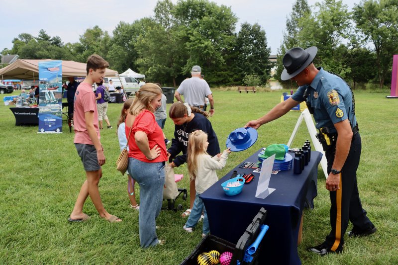 Madeline Pasqueal gets a hat from Sr. Cpl. Patrick Jackson of the Delaware State Police. The Pasqueal family came from Long Neck to check out Lewes Night Out.