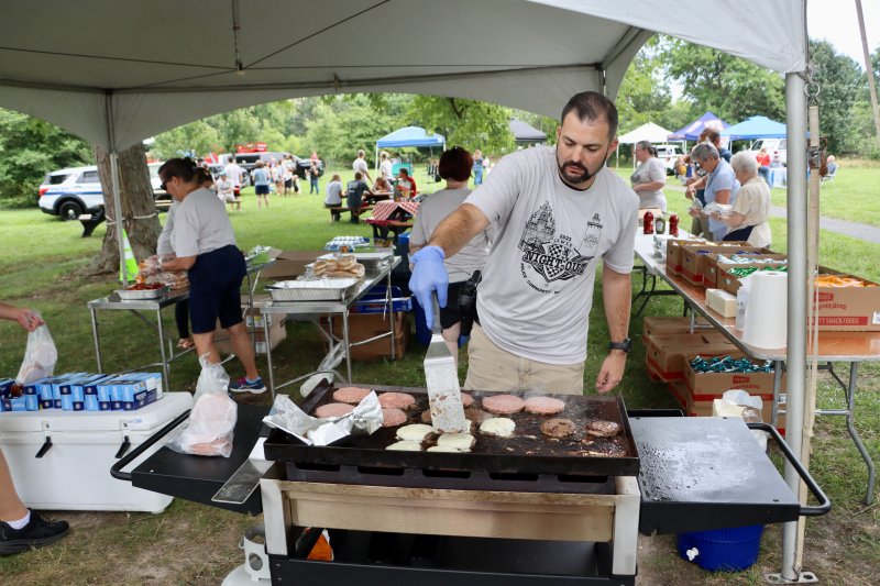 Lewes police officer Phillip Poorman mans the grill.