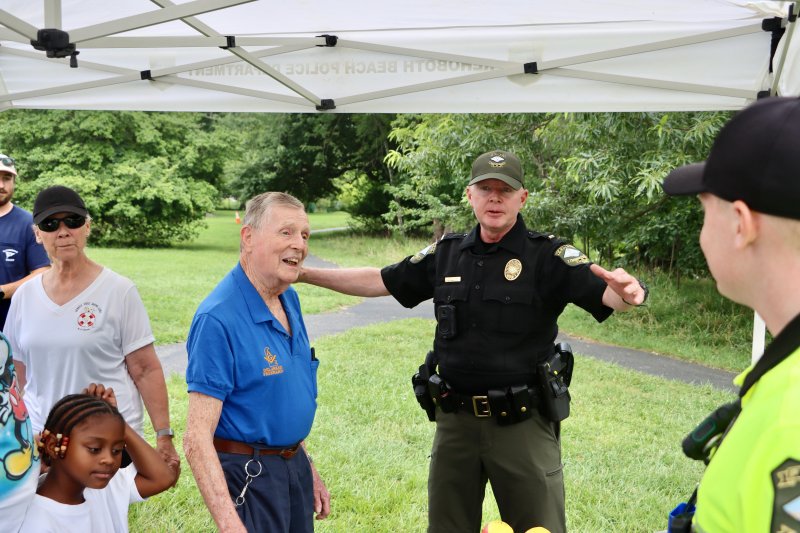 Retired magistrate Jim Horn, left, talks with Lt. Will Sullivan, middle, of the Rehoboth Beach Police Department.