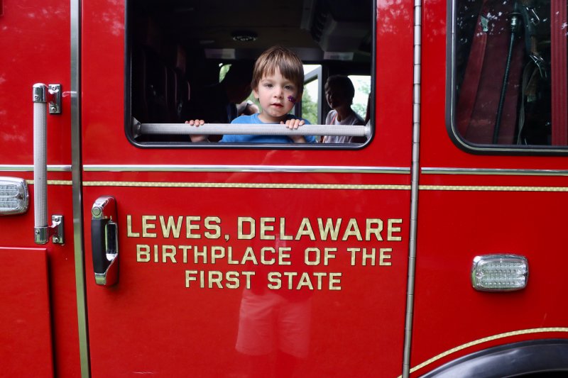 Caleb Salmon of Herndon, Va., looks out of a Lewes fire truck during Night Out Aug. 5. The annual celebration in George H.P. Smith Park allows citizens to interact with local law enforcement, first responders and city leaders. BILL SHULL PHOTOS