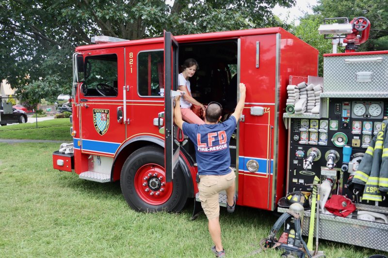 Lewes firefighter Joe Esposito shows off a truck during Night Out.