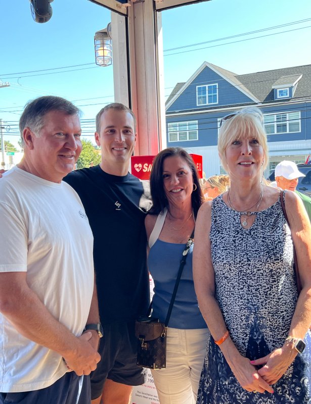 The Ashby family is joined by friends and neighbors at the ribbon-cutting event. Shown are (l-r) The Starboard owner Steve “Monty” Montgomery, Mike Ashby, Dewey local Joelle Genevish and Laura Ashby. Genevish donated the AED placed inside the tower.