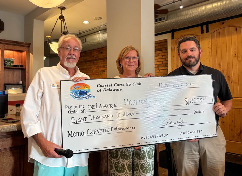 Coastal Corvette Club of Delaware President Richard Addington, left, presents a check for $8,000 to Delaware Hospice Director of Philanthropy Peggy Dolby. Also present is Chris Diaferio, general manager of i.g. Burton Lewes Automall. ELLEN MCINTYRE PHOTO