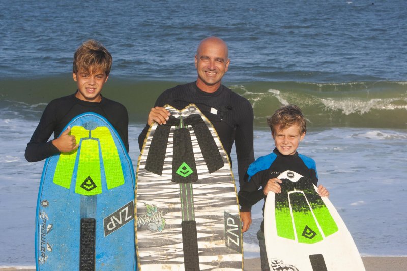 Jamie Celano stays young by skimboarding with his sons Jamie, left, and Luke.