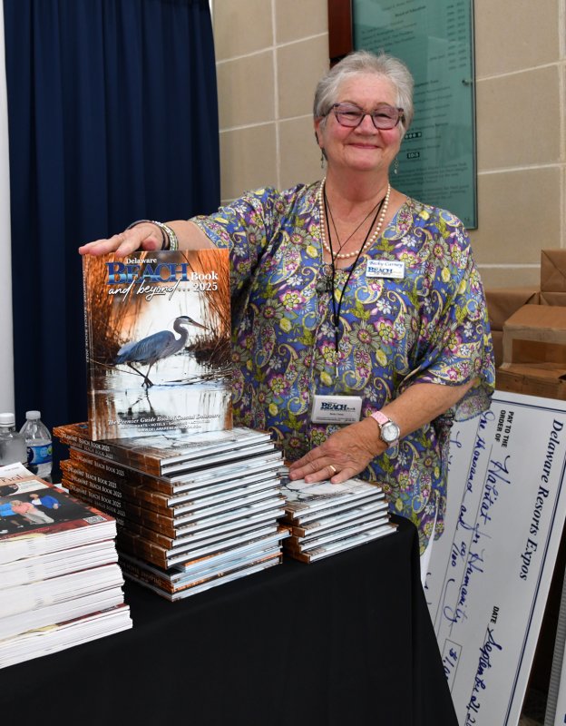 Becky Carney, owner of the Beach Book, hands out copies of the popular publication.