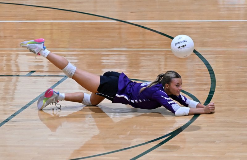 Royals senior Riley Barto makes a diving play on a serve.
