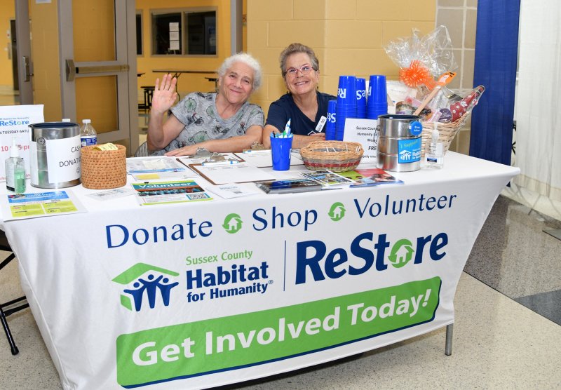 Theresa Mszar, left, and Becky Good welcome guests to the ReStore booth.