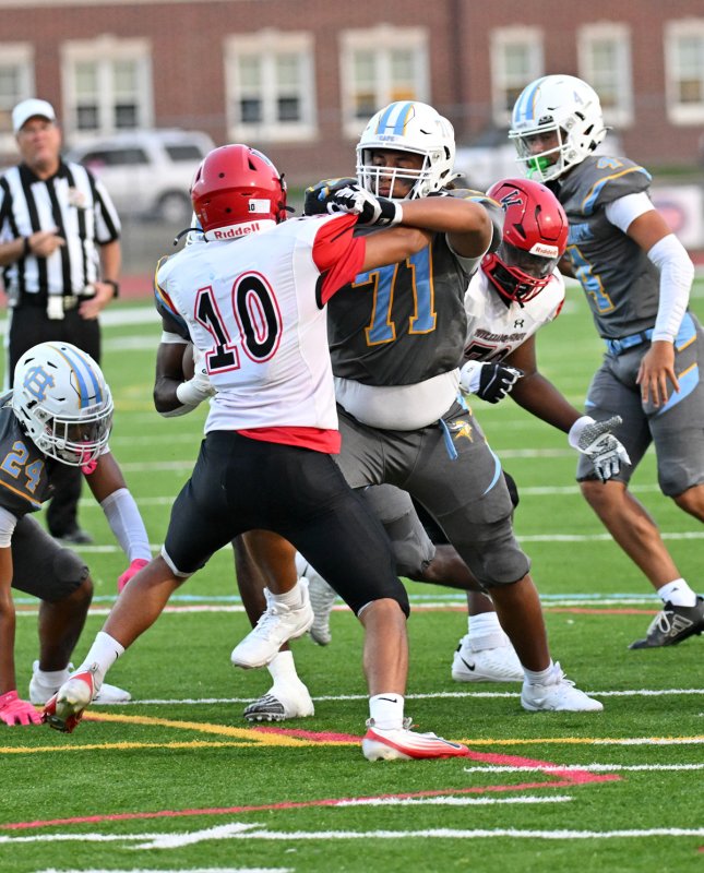 Cape’s Jayson Cohen blocks the Colonials’ Jayden Elliott.