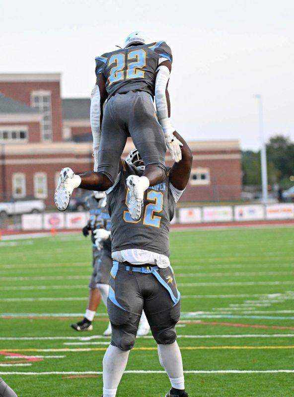 Tremaine Batson lifts his brother Oz after a score.