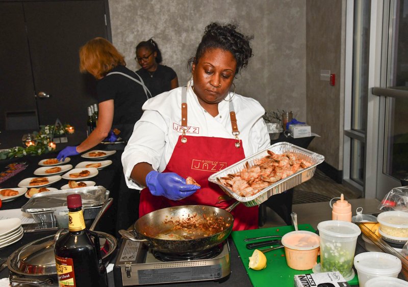 Latisha Dismuke of A Taste of Jazz prepares a dish.