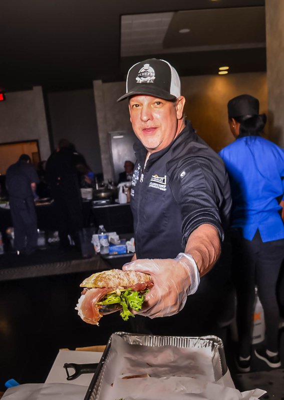 Peter Scioli of Touch of Italy serves a ciabatta hero sandwich for his second course.
