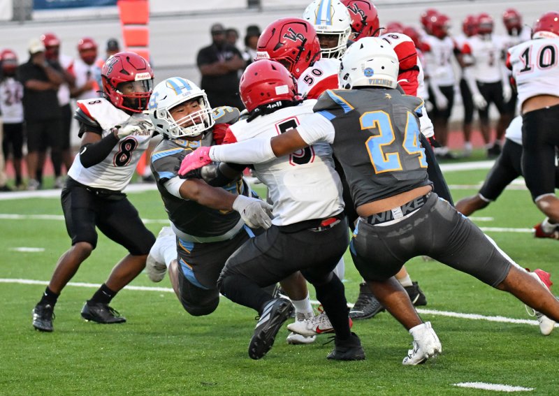Cape linebacker Javier Morales-Roblero, left, and teammate Del Richards do a tag-team tackle on Chase Foxworth.