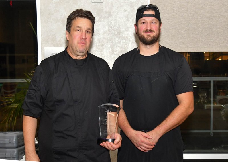 Winning best dessert are the father-and-son team of Richard, left, and Ryan Steele from Cafe Azafran. They served a tasty buttermilk panna cotta.
