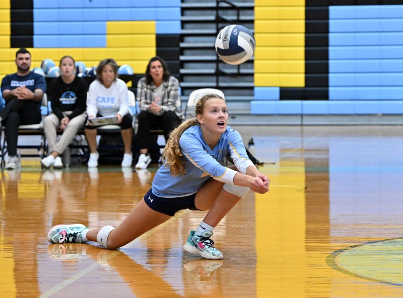 Cape junior Harper Mamele makes a diving play on a Delmar kill attempt.