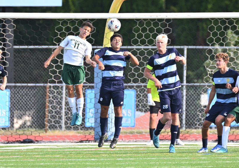 Cape defender Jorge Ruiz heads the ball away from the front of the cage.