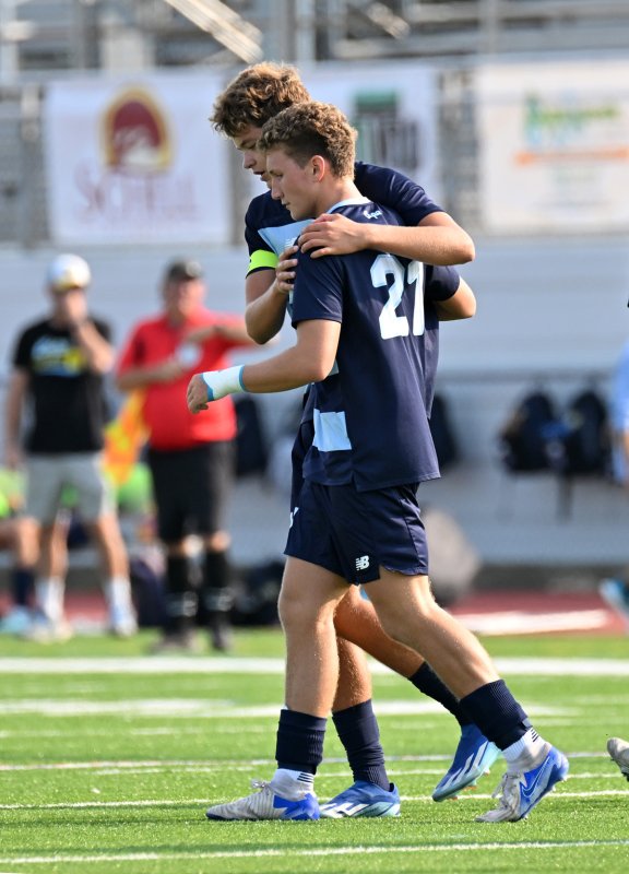 Cape senior Lee Levis congratulates Austin Tyndall on his third goal of the game.