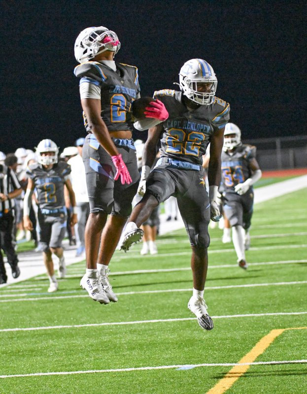 Del Richards celebrates his touchdown with teammate Oz Batson.