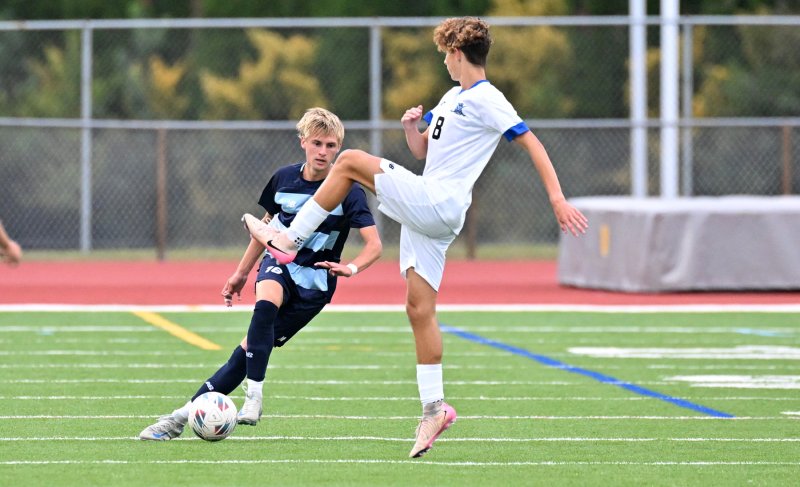 Cape junior Seth Benjamin puts a fake on Middletown’s Fabian Poluszanczyk.