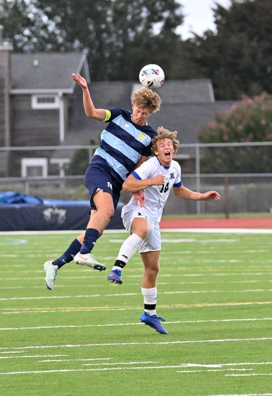 Cape senior Lawson Whaley gets major air to head the ball away from Middletown’s Braxton Wortman.