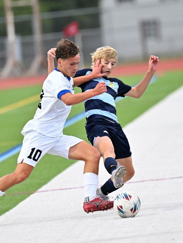 Cape’s Colby Wheeler battles for possession with Middletown’s Mason Harrison.