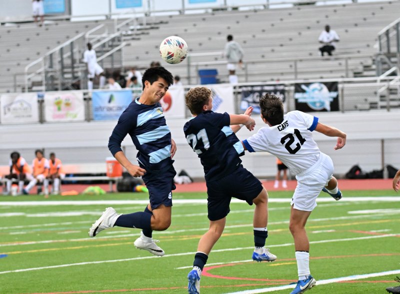 Cape senior William Burke, left, heads the ball upfield.