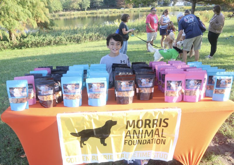 Young entrepreneur Evan Hauff displays his dog treats at the event.