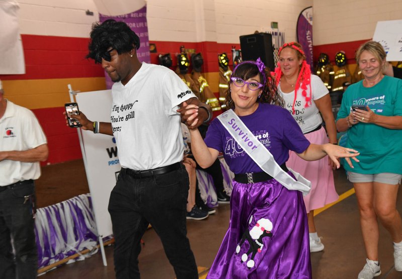 Connie Jamele, right, struts around the survivor walk with her friend Anthony Hilton. She also won the Relay for Life costume contest. DAN COOK PHOTOS