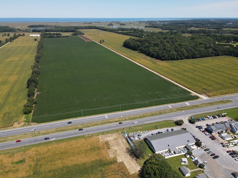 The Robinson farm is the site of a proposed cluster subdivision going before the Preliminary Land-Use Service Wednesday, Sept. 3. The plan includes the green field and cuts in behind the wooded area to the right. NICK ROTH PHOTO