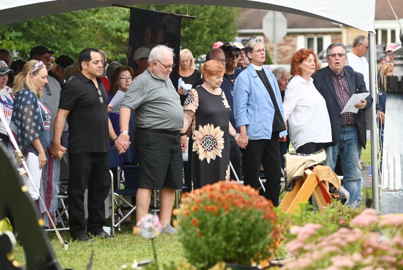 Among those holding hands are (l-r) Phillip Cruz, Roger Whitford, Carol Whitford, the Rev. Karis Graham and Carol Webster.