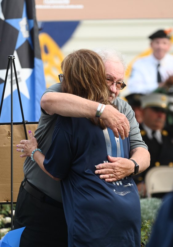 Roger Whitford embraces one of the volunteers who help make the annual event possible.