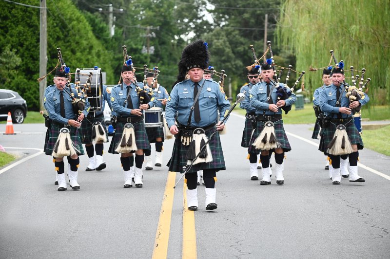 Sgt. Dan Salfas leads the Delaware State Police Pipes and Drums procession to the Whitford home.