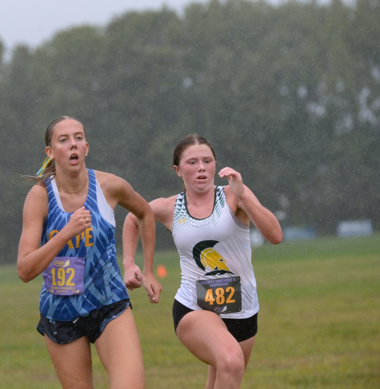 Emma Thompson of Cape (23:29) battles Paige Bienkowski of Saint Mark’s (23:28) in the final stretch.
