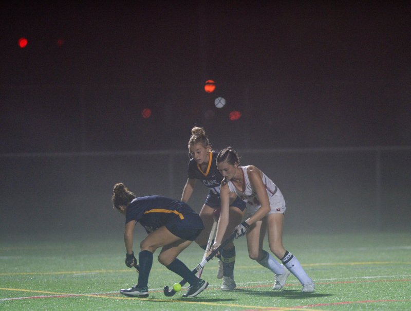 Shrouded and surrounded – Bree Moffett pulls the ball to her stick for the winning shot. DAVE FREDERICK PHOTO