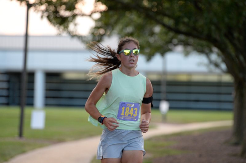 Sofiya Kirtadzhieva wins the female race at the Run, White & Blue 5K in 20:30.