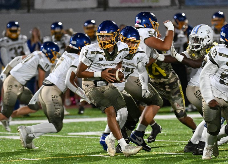 Central senior quarterback Josiah Cannon takes the snap and rolls out.