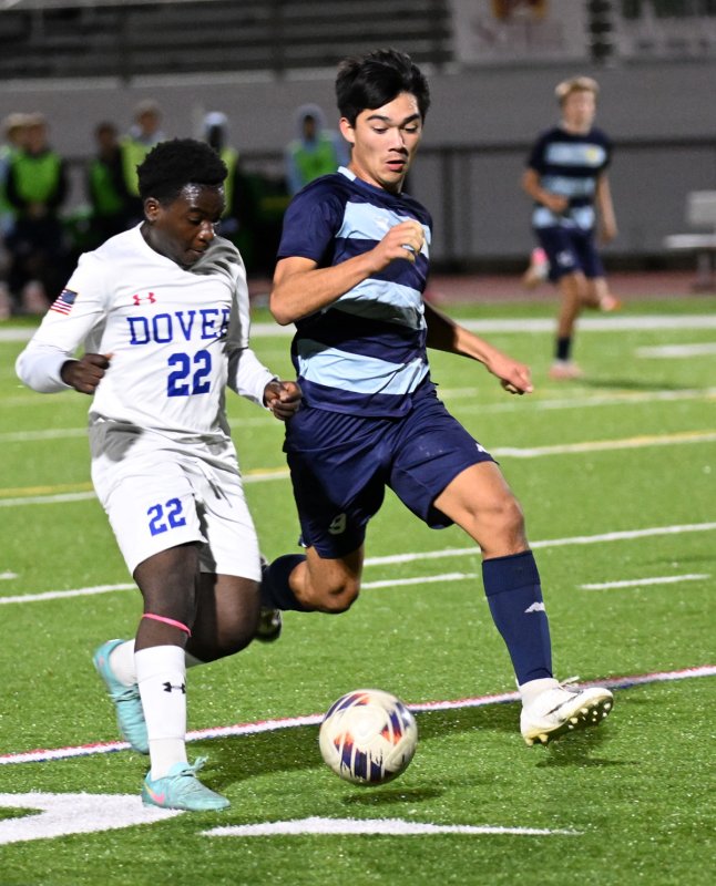 Cape senior Will Burke, right, battles for a 50/50 ball with Dover’s Diego Ballestas.