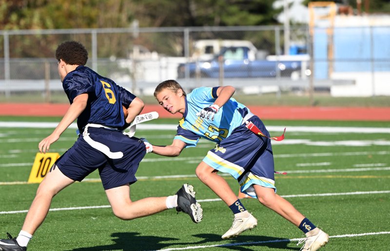 Cape defensive back Jaxson Holgerson pulls the flag from Seaford’s Timothy White.