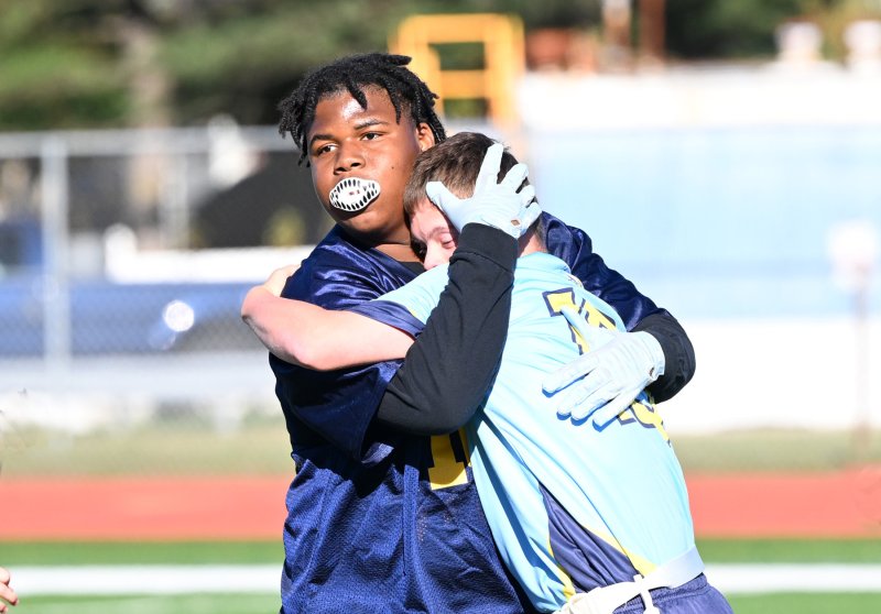 In a first-rate showing of sportsmanship, Seaford senior Berson Macean gives Cape’s Luke Archer a hug after he was inadvertently knocked to the turf. DAN COOK PHOTOS