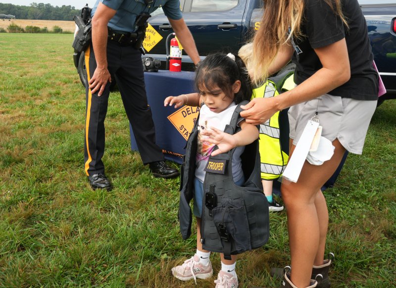 Elizabeth Machic Cotoc tries on a state trooper vest.