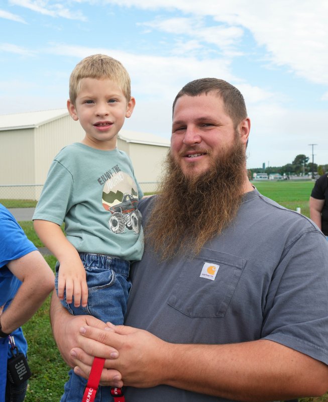 John Adkins holds his son Hudson.