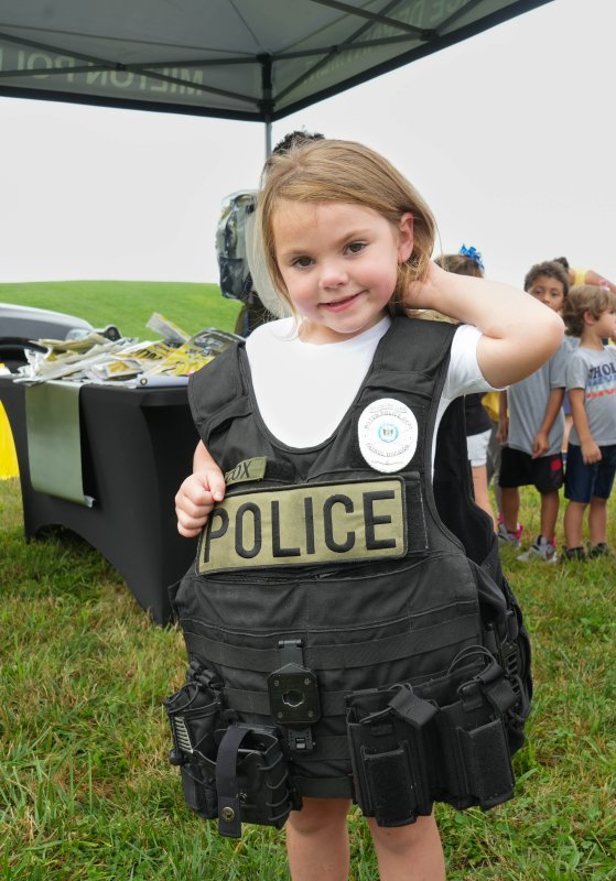 Brynnleigh Abele tries on a Milton Police Department vest.