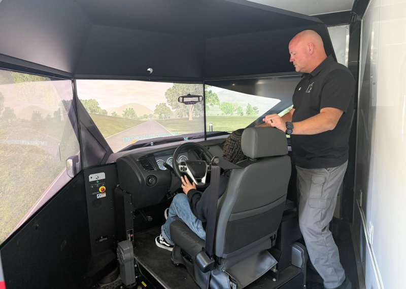 Cpl. Keith Shyers gives Lexianna McCoy instructions during the distracted driving simulation.