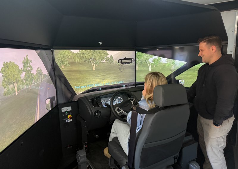Cpl. Erick Warner oversees Emma Cordy’s driving simulation.