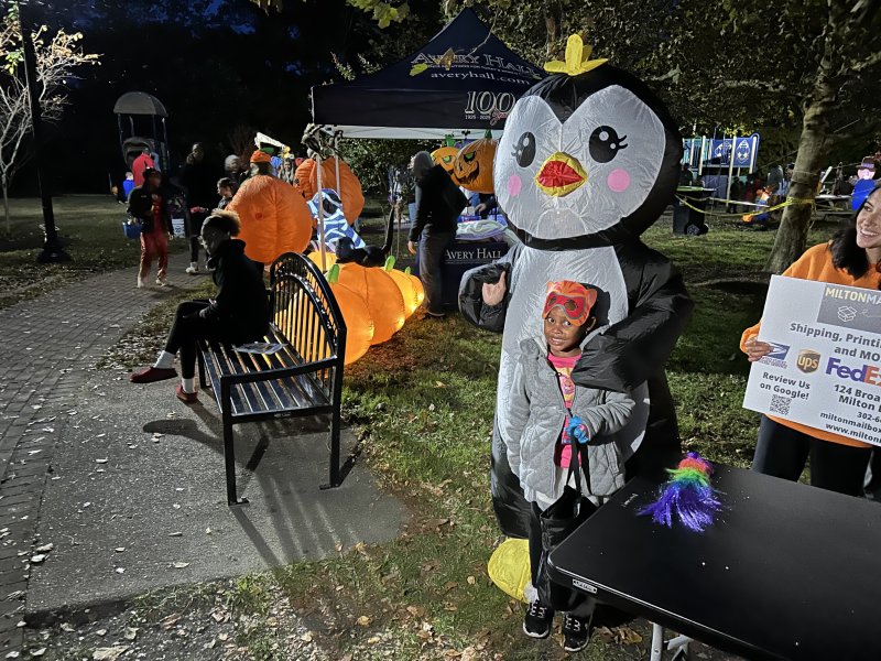 Kamryn Johnson, 5, takes a picture with the Milton Mailboxes penguin.