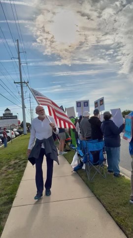 Rick Bost waves the American flag. JACKIE SHOCKLEY PHOTO