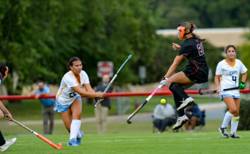 A Polytech corner defender jumps away from a hard shot by Emily Wells.