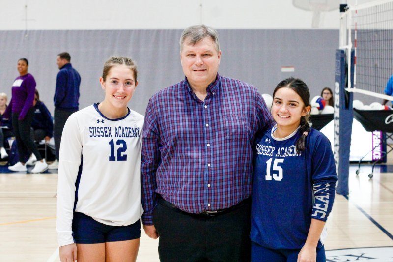 Seahawks freshmen Reagan Klahr and Patti Lara Nieto pose with John Reichenberg.
