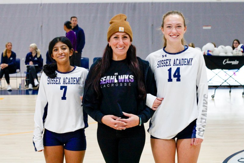 Sussex Academy senior Ellie Merrick, right, walks with her lacrosse coach Kim Raschdorf and Rebecca Thomas.